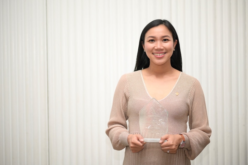 Tu Le, Solicitor at Marrickville Legal Centre, holds an award.
