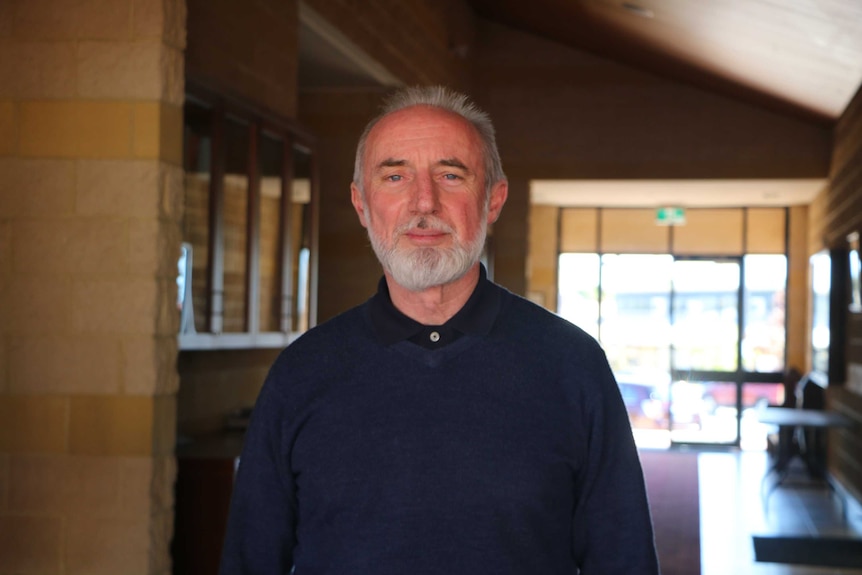 Father John Daly, priest at St Anthony's in Perth stands alone in the church foyer.