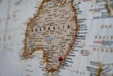 A map of the world zoomed on Australia with a pin in Sydney