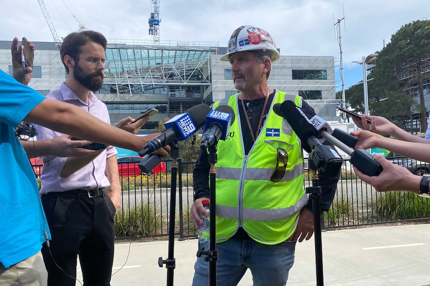CFMEU state secretary Mick Buchan speaks to reporters in front of a building where a roof collapsed at Curtin University.