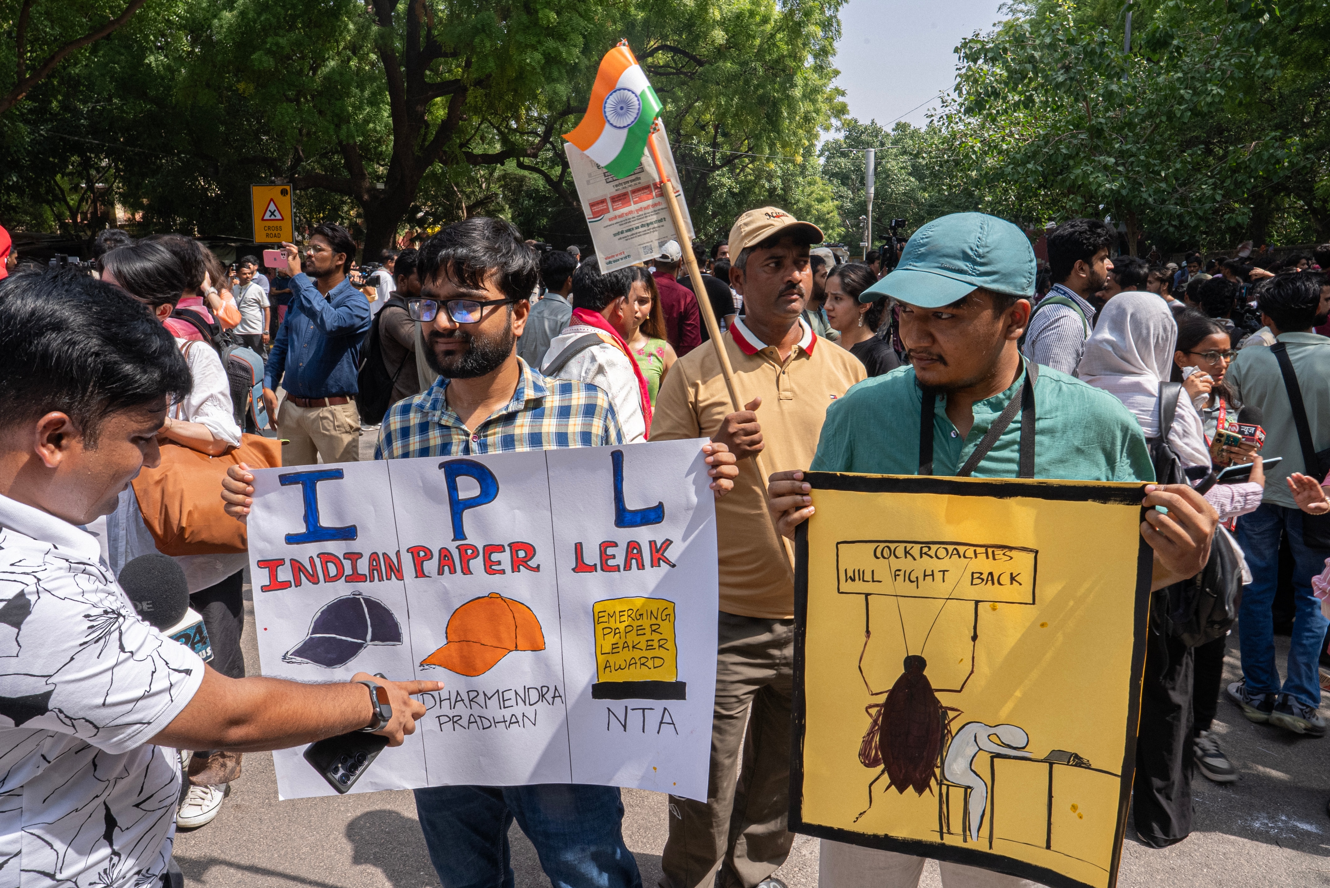 Protester holds a homemade board calling out exam leaks in India