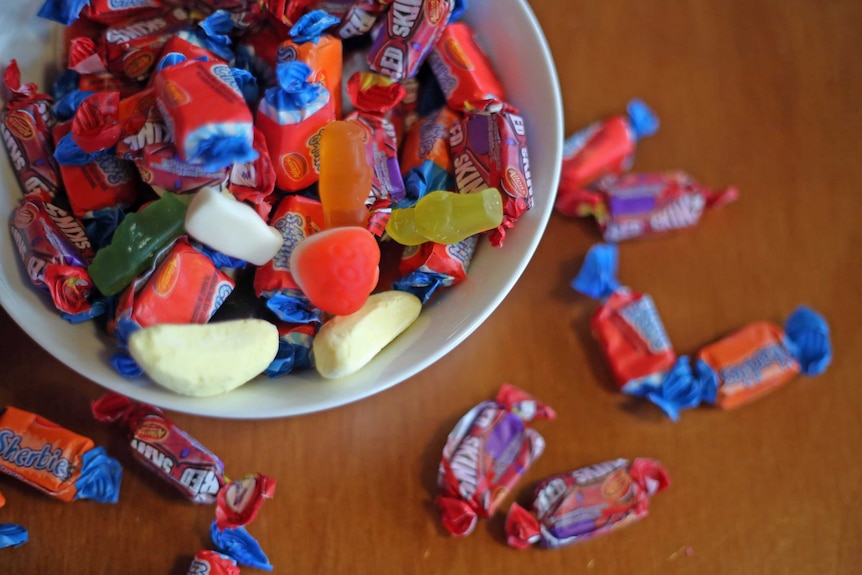 A bowl full of Allen's lollies, including Sherbies and Oddfellows.