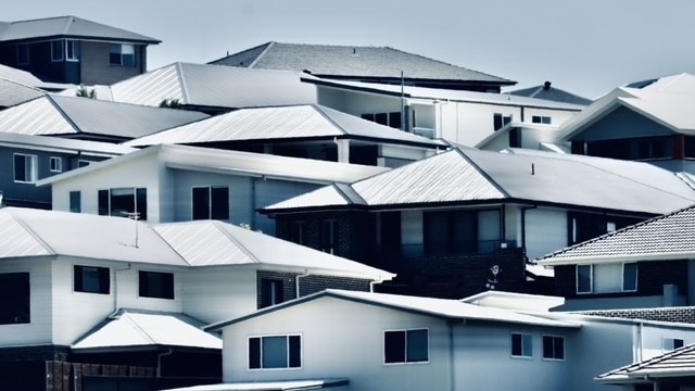 New houses sit on a hillside in a housing estate at Albion Park.