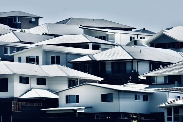 New houses sit on a hillside in a housing estate at Albion Park.