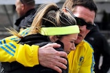 A woman is comforted by a man after the explosions.