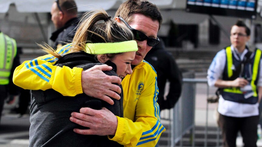 A woman is comforted by a man after the explosions.