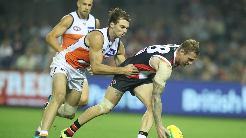 Tim Membrey of St Kilda attempts to pick up the ball