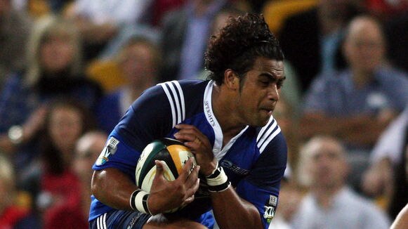 Taniela Moa of the Blues takes on the Reds defence