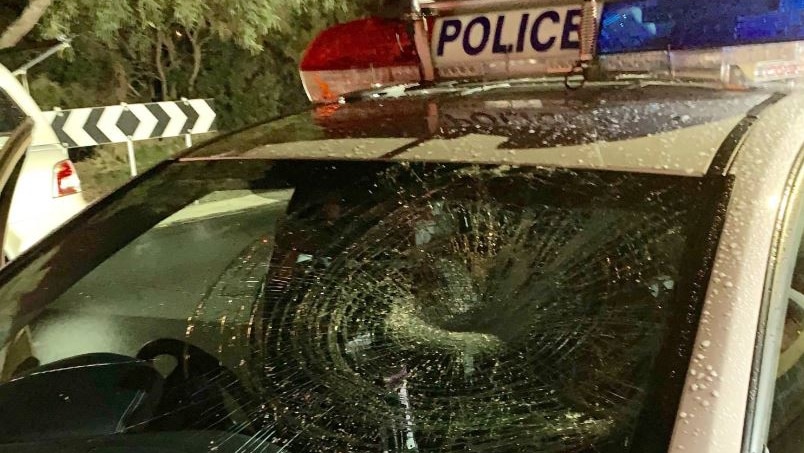 A smashed windscreen of a police patrol car