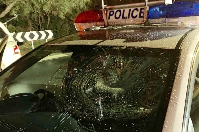 A smashed windscreen of a police patrol car