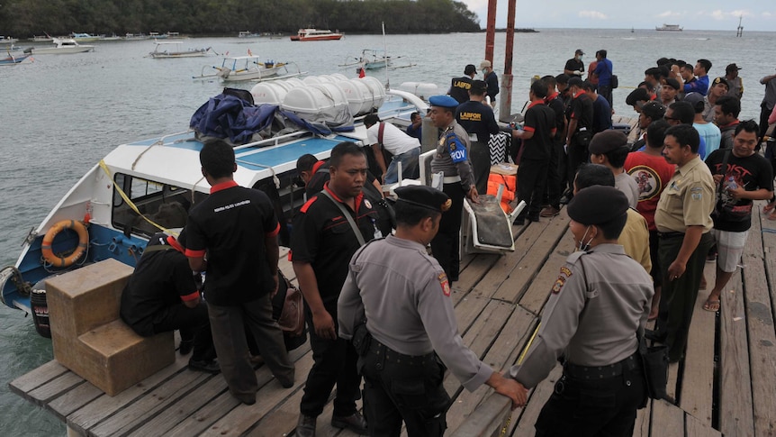 Police conduct investigations on a speedboat following an explosion on the vessel in Indonesia's resort island of Bali.