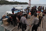 Police conduct investigations on a speedboat following an explosion on the vessel in Indonesia's resort island of Bali.