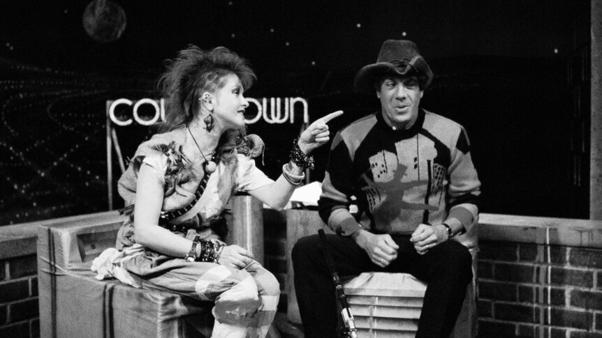 Cyndi Lauper (left) points to host Molly Meldrum (right) on the Countdown set.