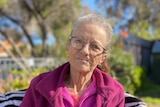 JobSeeker recipient Wendy Morgan sits outside her apartment in Adelaide.