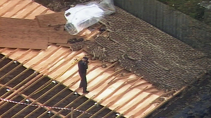Police examine a brick wall that collapsed killing a man in Brighton East