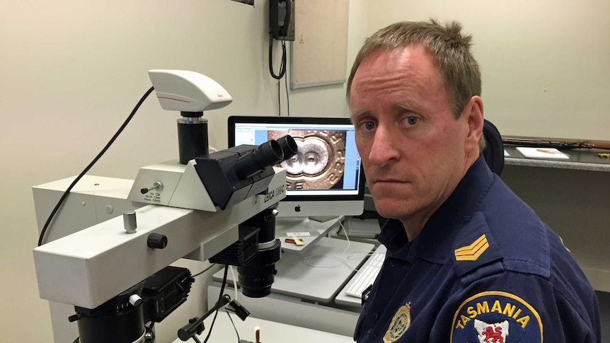 Tasmania Police Sergeant Gerard Dutton in front of equipment