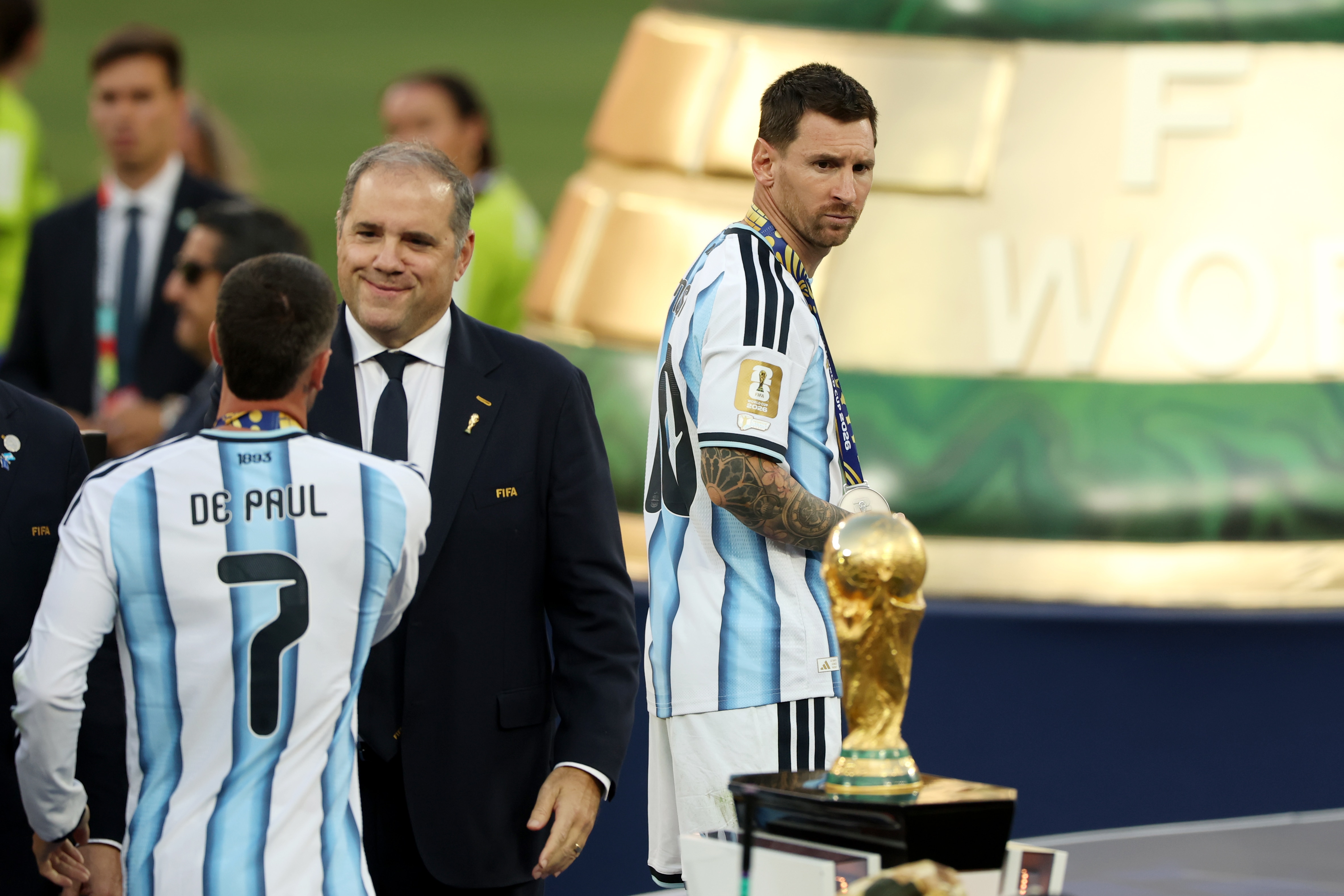 Lionel Messi looks back at the World Cup trophy