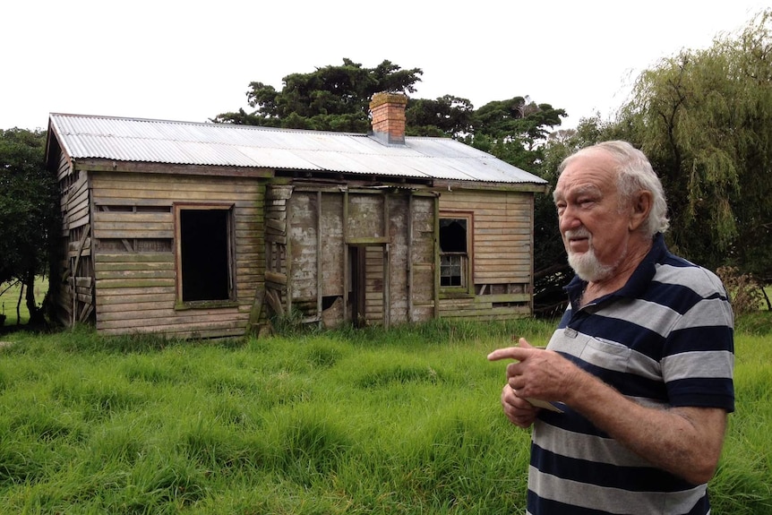 Len Sullivan shows the remnants of the house built by his father, Clifford Sullivan, on the family property.