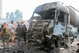 Soldiers inspect the site of an explosion in Tartous.