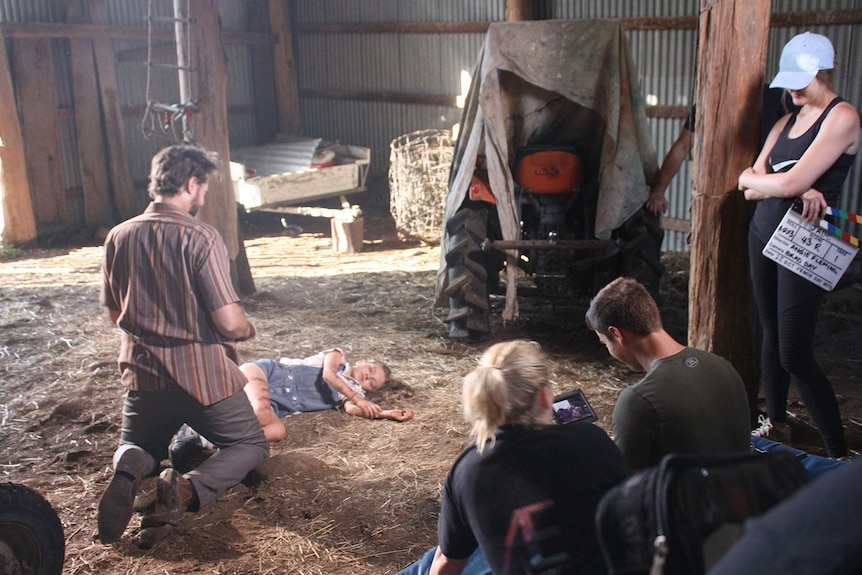 Actors Daniel Potts and Summer Robertson in a barn in a scene from the film Jade.