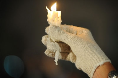 A Michael Jackson fan - wearing the star's trademark single white glove - holds a candle in his memory outside the UCLA Medic...