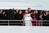 Pope Benedict waves to pilgrims on the foreshore of Sydney Harbour.