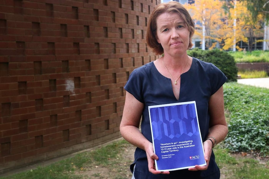 Debbie Noble-Carr holds her report.