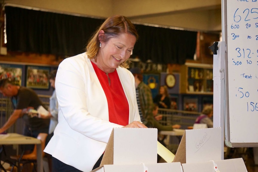The Labor Member for Gilmore inserts her vote into a white at a box