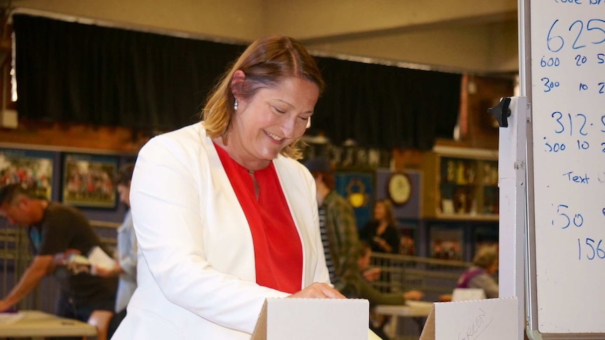 The Labor Member for Gilmore inserts her vote into a white at a box