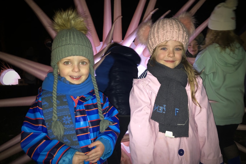 a small boy and girl smile at the camera