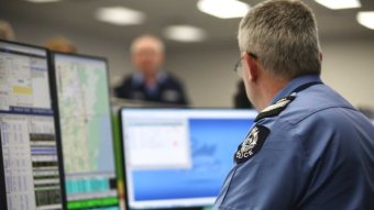 WA Police officer sits at computer