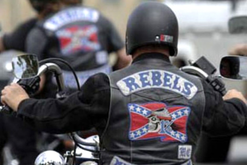 men on motorcyles with Rebels insignias on the back of their leather jackets