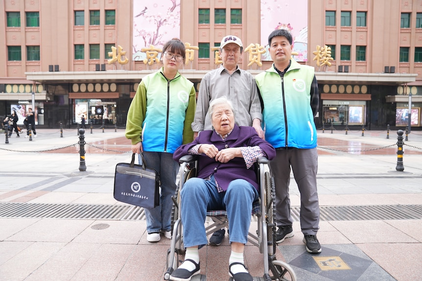 Two case workers with an elderly couple.