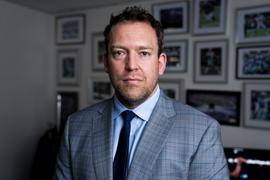 A lawyer in a suit and tie inside his office.