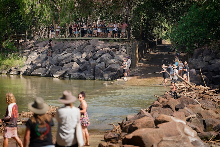 People fishing over the notorious Cahills Crossing that crosses over the East Alligator River from Kakadu into Arnhem Land.