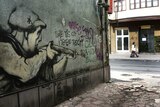 Graffiti in Sarajevo of an armed citizen declaring: "I love this city, I defend this city".