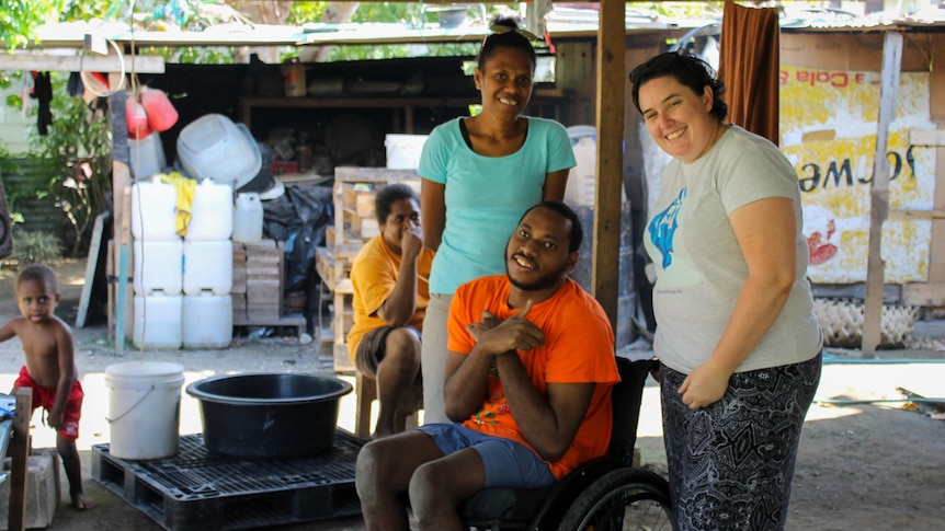 VSPD's Delmay Tarago, client Paul Makali and MA's Katrina McGrath at a wheelchair fitting.