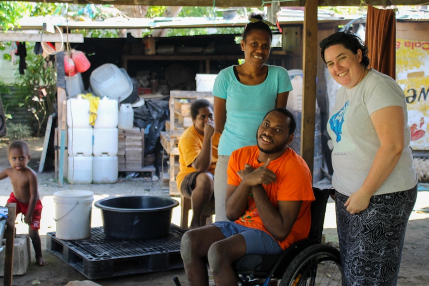VSPD's Delmay Tarago, client Paul Makali and MA's Katrina McGrath at a wheelchair fitting.