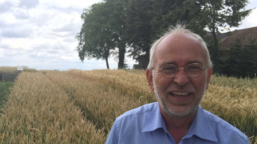 Germany's most famous farmer, 'Farmer Willi,' standing in front of test crops