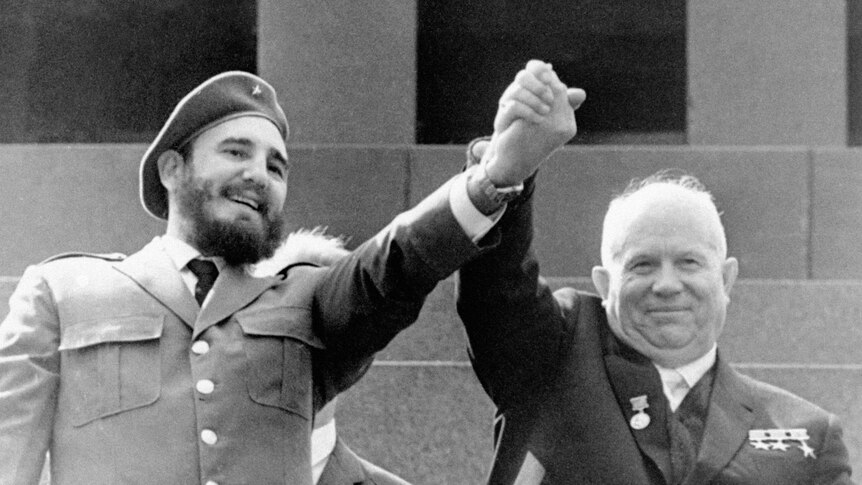 Cuba's leader Fidel Castro, left, and Soviet Premier Nikita Khrushchev clasp hands in the air.