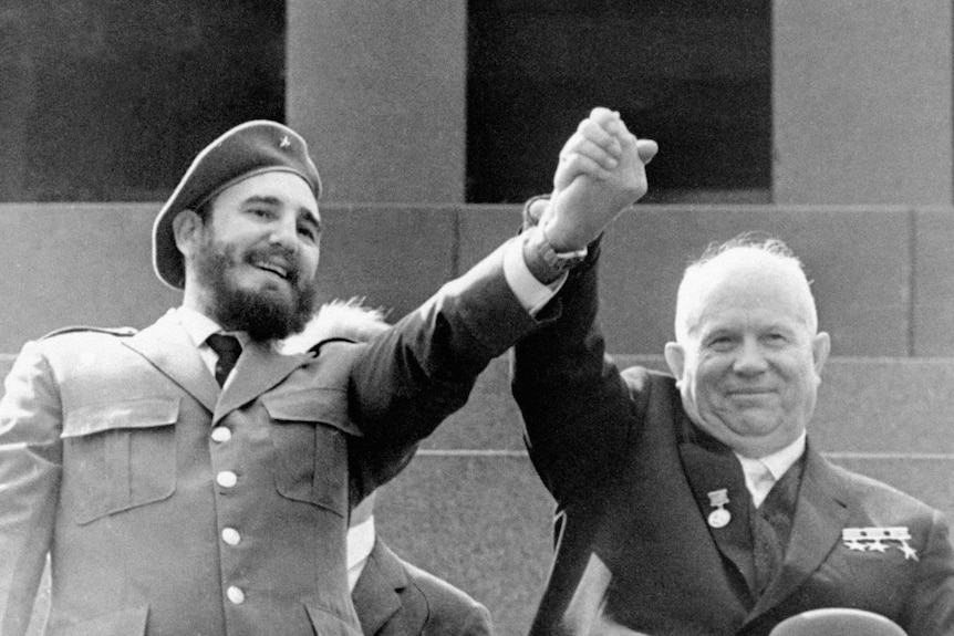 Cuba's leader Fidel Castro, left, and Soviet Premier Nikita Khrushchev clasp hands in the air.