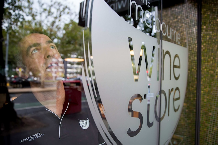 Tony Torcasio looking through the window of the Melbourne Wine Store