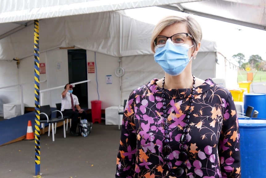  Woman wearing mask outside health tent