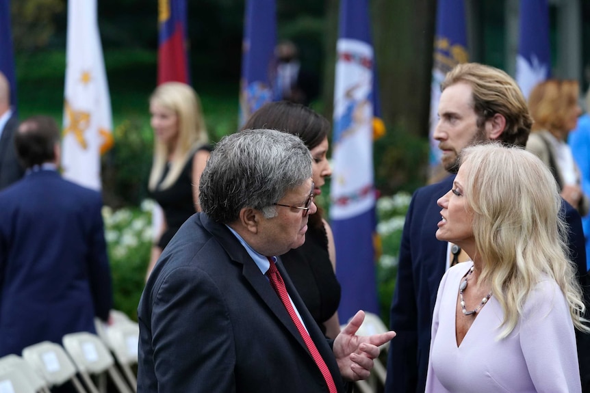 William Barr speaks to Kellyanne Conway in the Rose Garden.