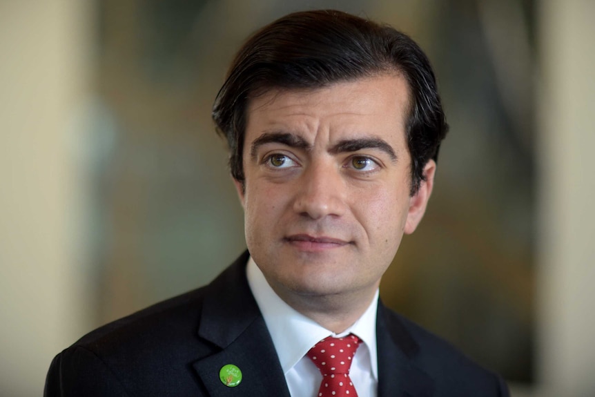 Senator Sam Dastyari speaks to the media after a Senate inquiry into credit card surcharges at Parliament House.