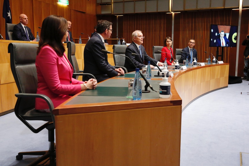 National Cabinet leaders sit in tiered seating with Mark McGovan on a screen