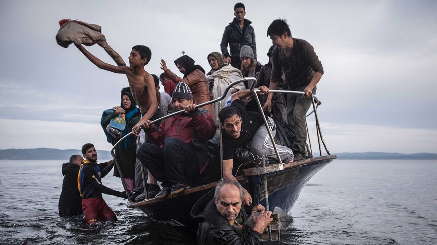 Refugees arrive by boat near Lesbos, Greece.