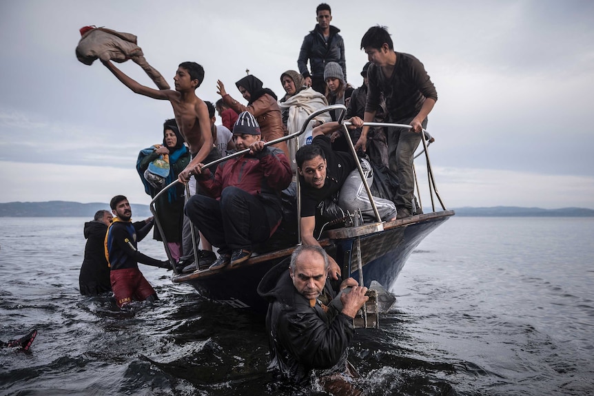 Refugees arrive by boat near Lesbos, Greece.