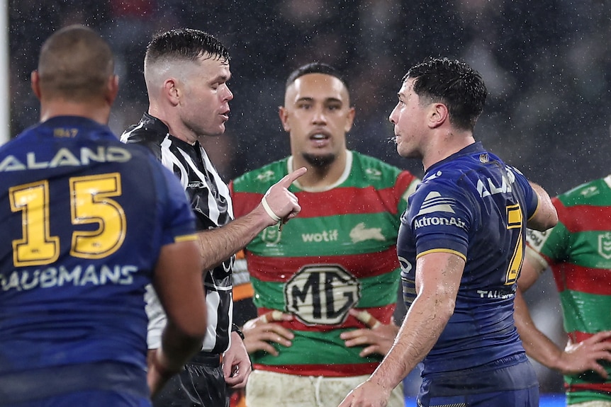 Referee Liam Kennedy speaks to Parramatta Eels player Mitchell Moses during an NRL game.