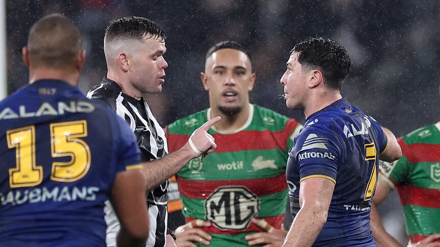Referee Liam Kennedy speaks to Parramatta Eels player Mitchell Moses during an NRL game.